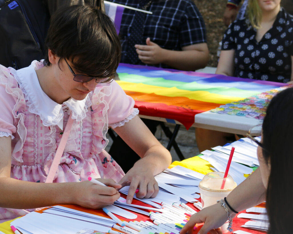 A student decorates a slap bracelet at SAC’s National Coming Out Day celebration Oct. 10. Photo by D.J. Agleton