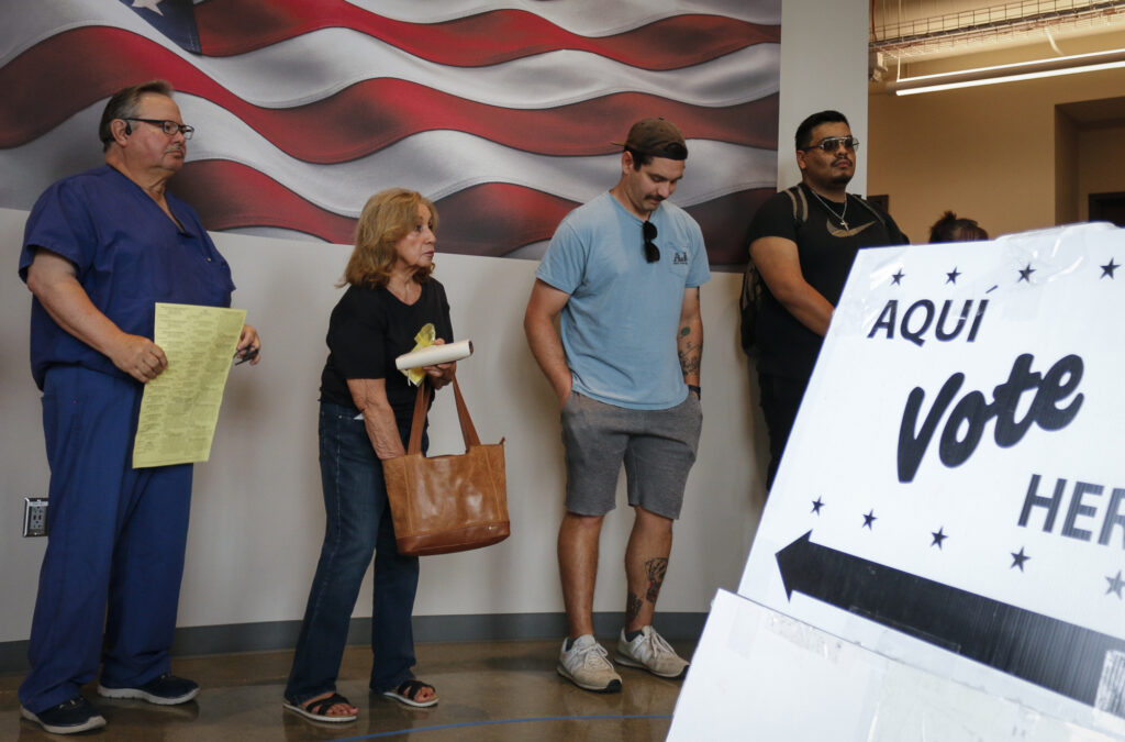 Bexar County residents line the hallway outside San Antonio College’s Victory Center Room 117 Tuesday to cast their votes in the 2024 general election. Photo by D.J. Agleton.