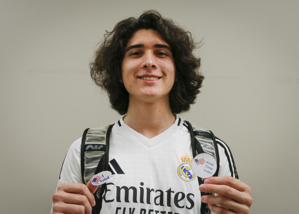 SAC Student Von Villareal shows off his voter stickers while posing for a picture after voting in the 2024 general election at SAC's Victory Center Tuesday. Photo by D.J. Agleton.