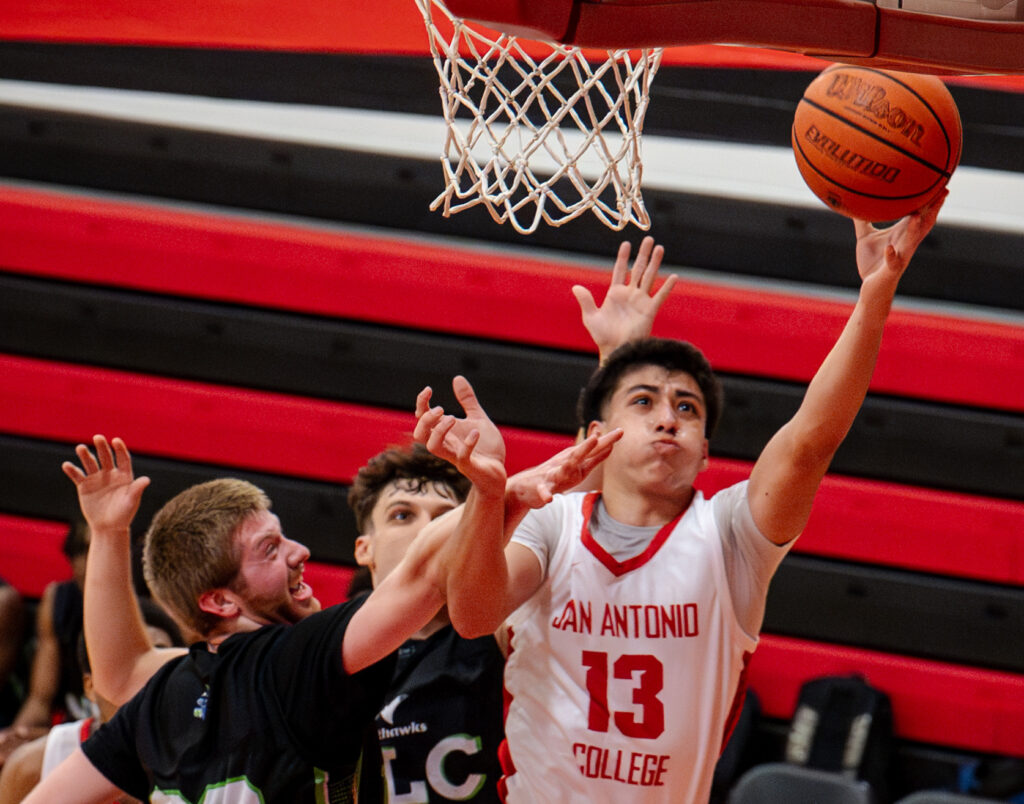 Armadillos forward Luke Lopez battles past two Nighthawk defenders for a layup at the Candler Physical Education Center Oct. 2. Photo by A. De Leon.