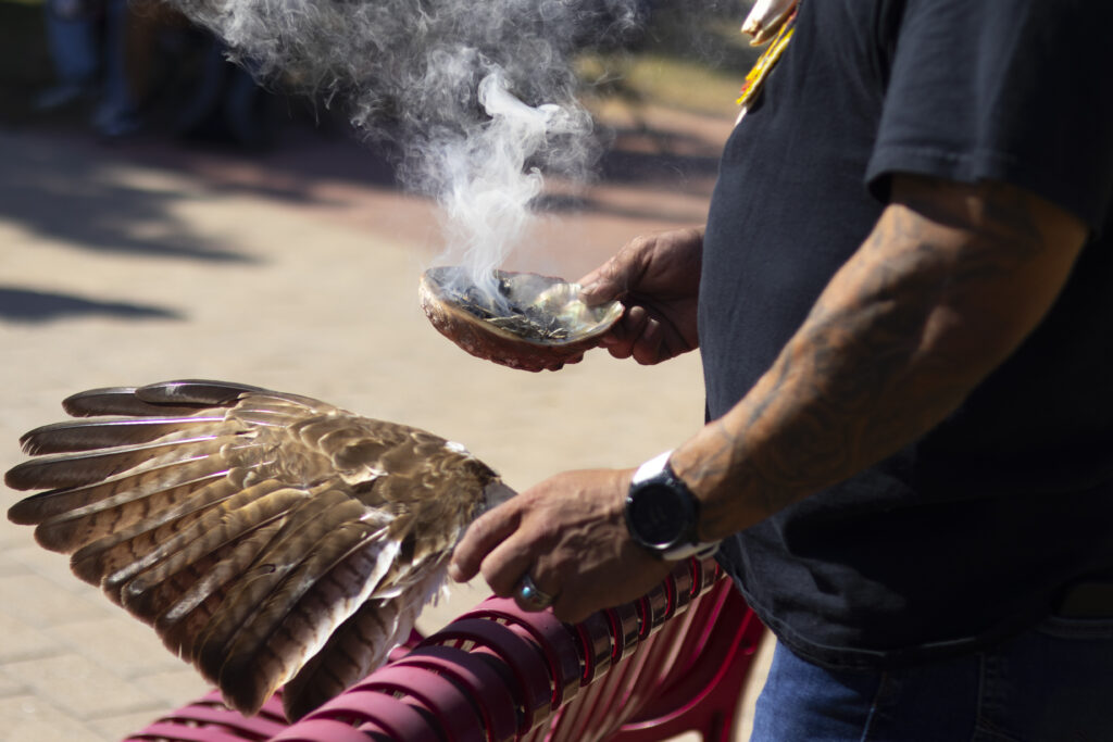 Rey Chavez burns sacred plants in a “smudging ceremony” to cleanse and purify the people and space during SAC’s Indigenous People’s Day celebration Oct. 14 in the mall area. Photo by Marianne Arrias.