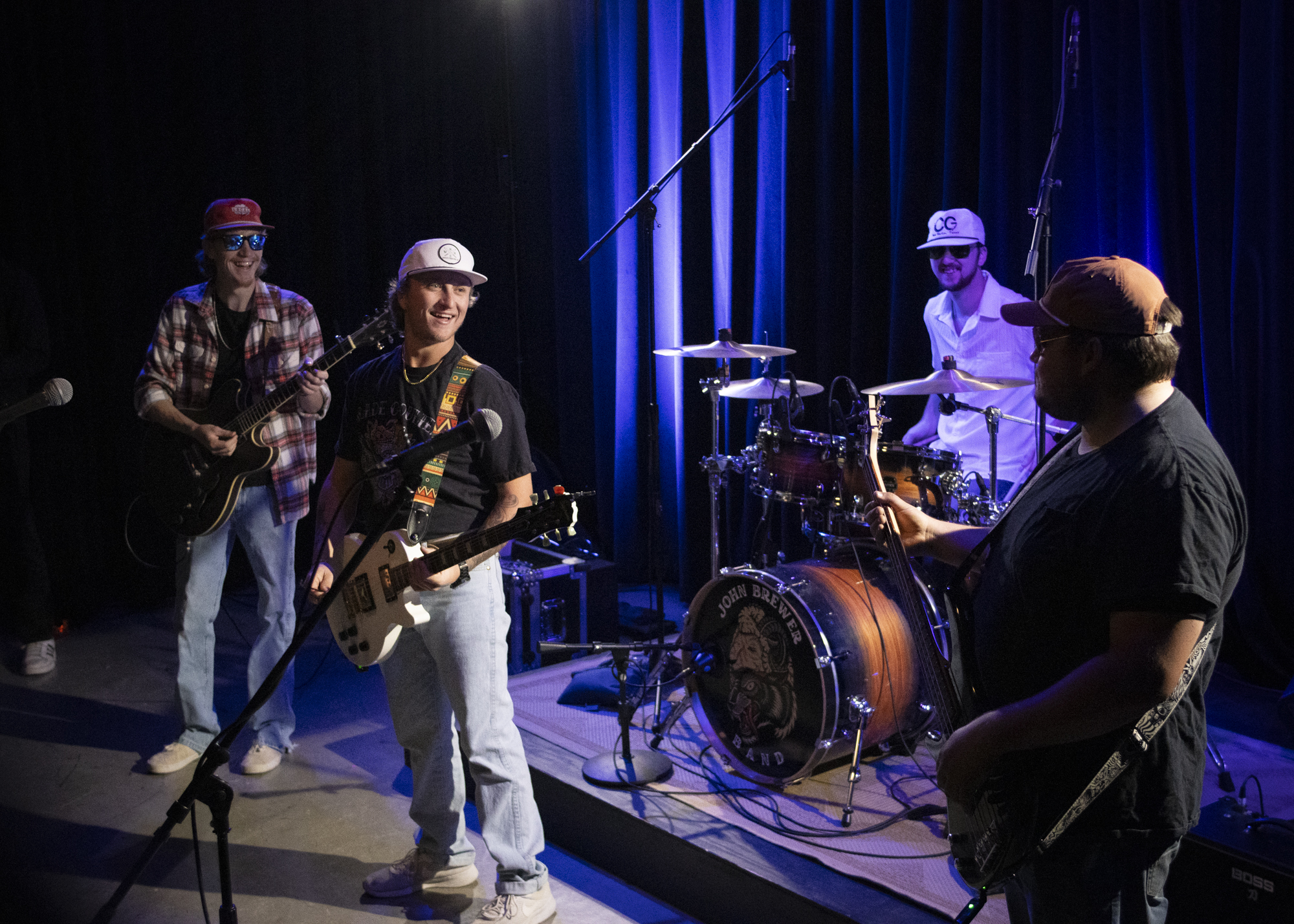 Members of “John Brewer Band” talk in Studio B of the Radio Television, and Film building during their music video shoot Oct. 15. Photo by Pablo Viveros.