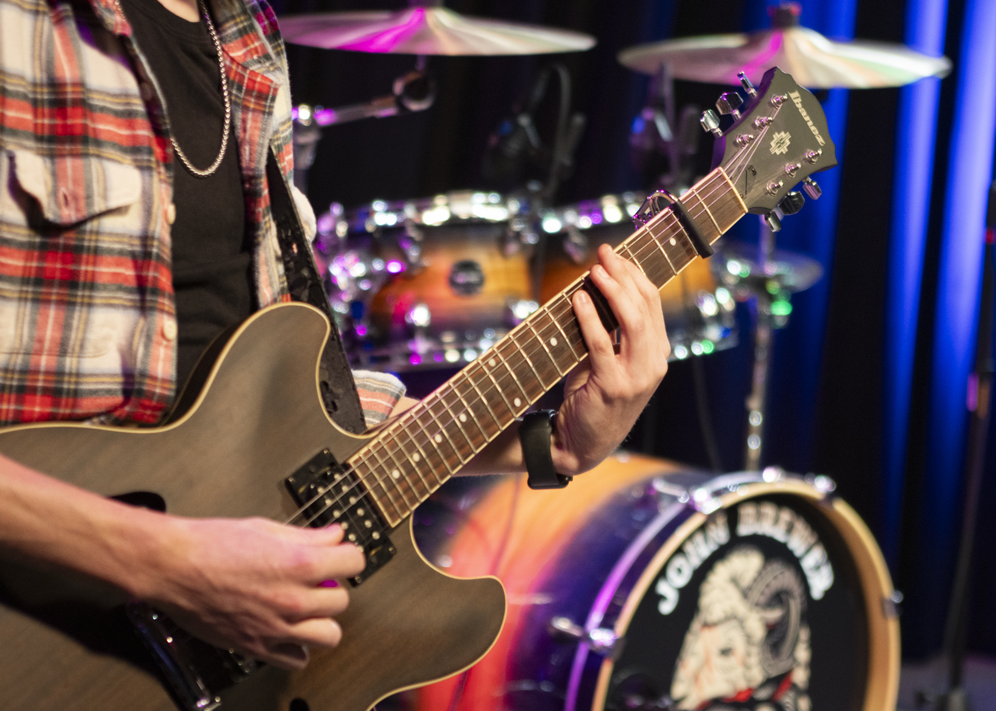 Bryce Irving, a sophomore who worked on the video production, played guitar for the "John Brewer Band” during the music video shoot in Studio B of the Radio Television, and Film building Oct. 15. Photo by Pablo Viveros.