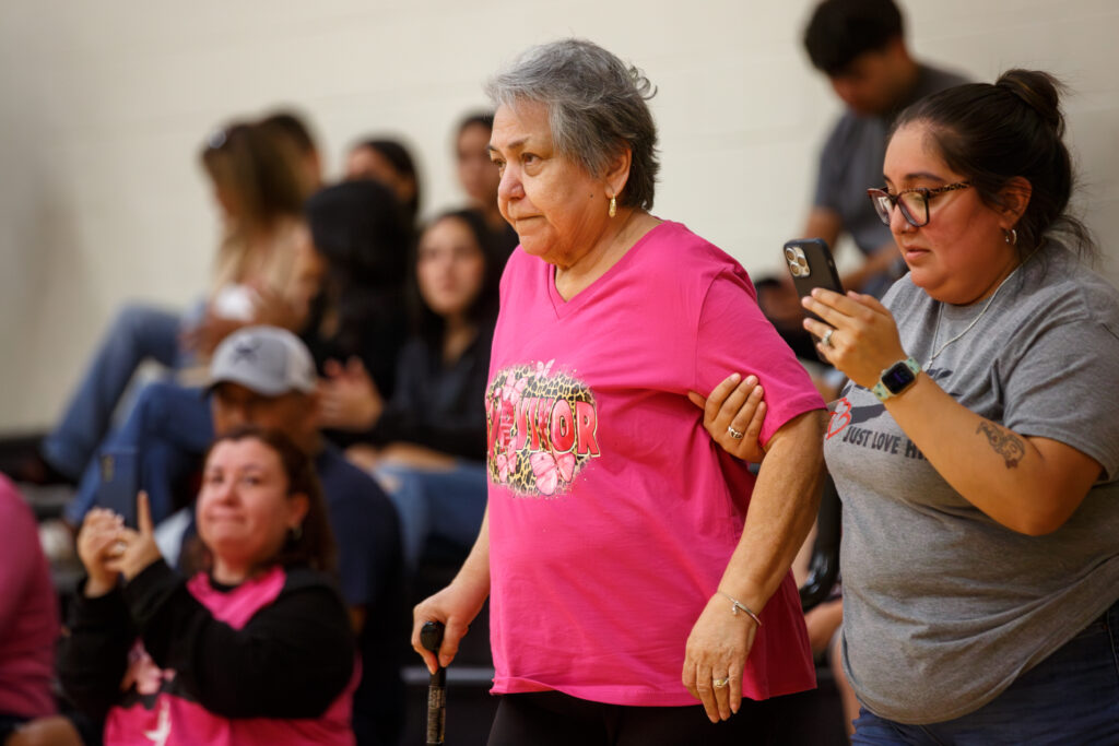 A Breast Cancer Survivor stands to be recognized before the Armadillos vs Palominos women's basketball game at the Abraham Kazen Middle School Gym Oct. 9. Photo by A. De Leon.