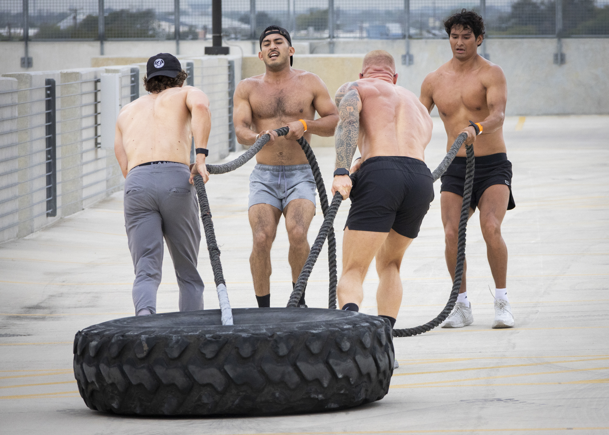 Team OTF pulls a tire in the final event of the Backyard Beast Team Fitness Challenge at Parking Garage 3 Nov. 1. The team set a new course record of 21:41 and collapsed in exhaustion after crossing the finish line. Photo by Pablo Viveros.