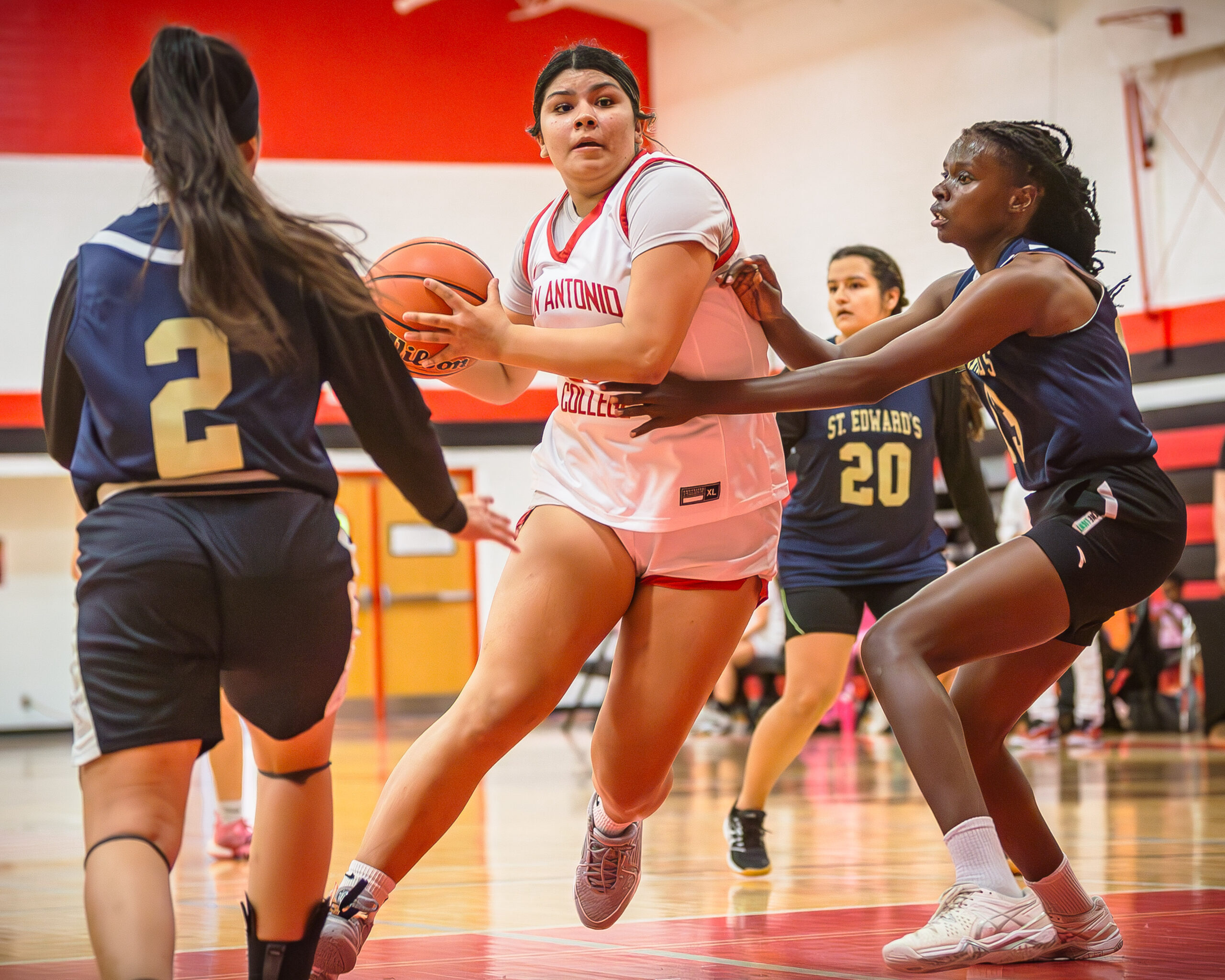 SAC's Nina Garcia drives past SEU defenders at the Candler Physical Education Center Oct. 30. Photo by A. De Leon.