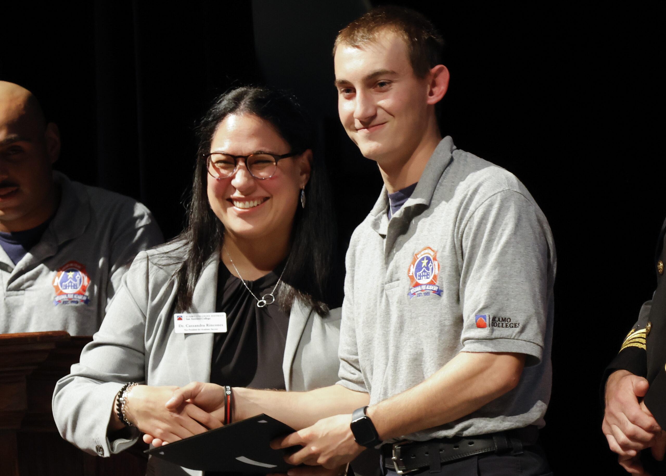 Dr. Cassandra Rincones, vice president for student success at SAC, congratulates a Fire Academy graduate at Northwest Vista College Dec. 13. Photo by Natalia Edwards.