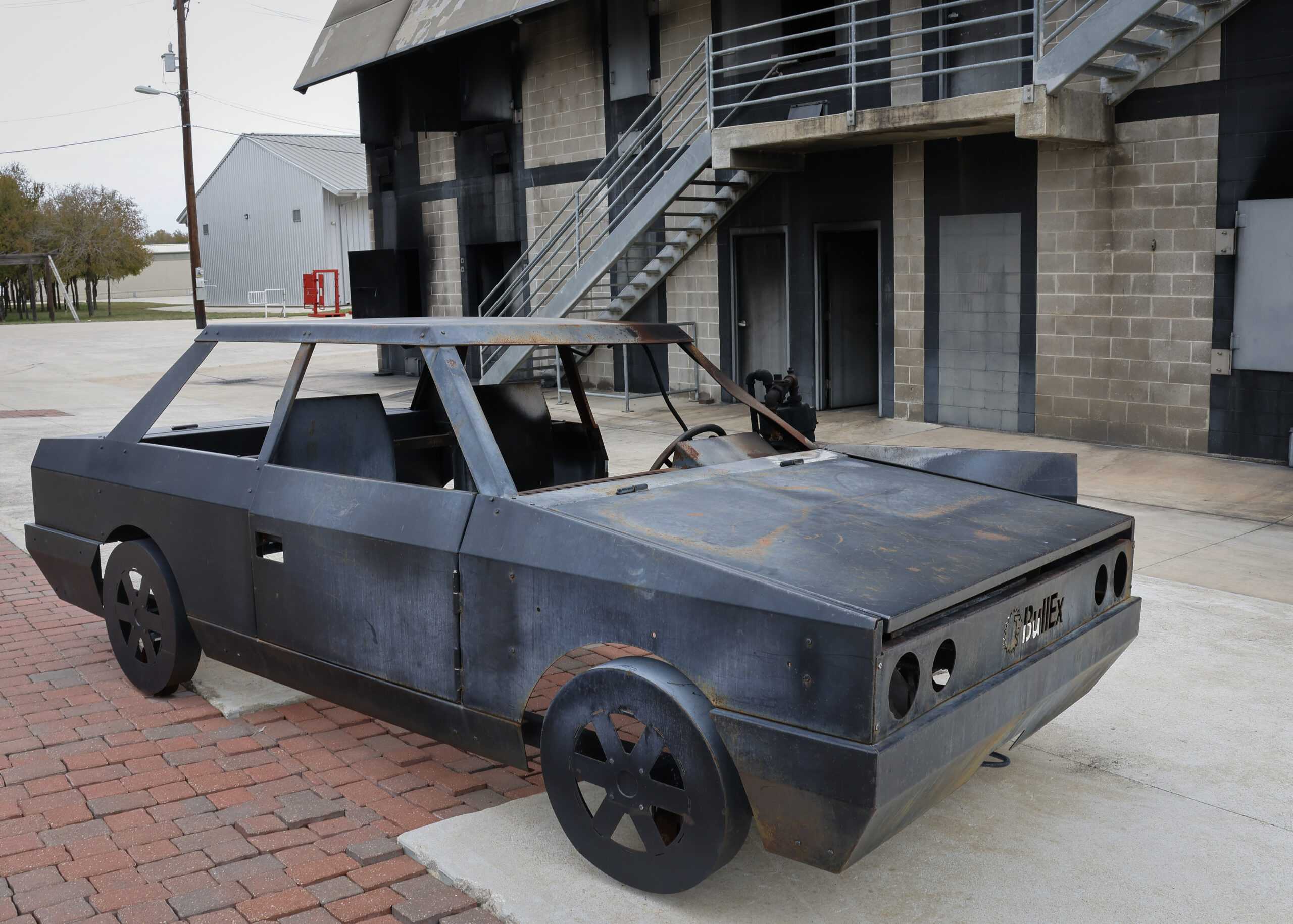 A mock vehicle at the Fire Academy is used to train cadets on extinguishing a vehicle fire. Photo by Natalia Edwards.