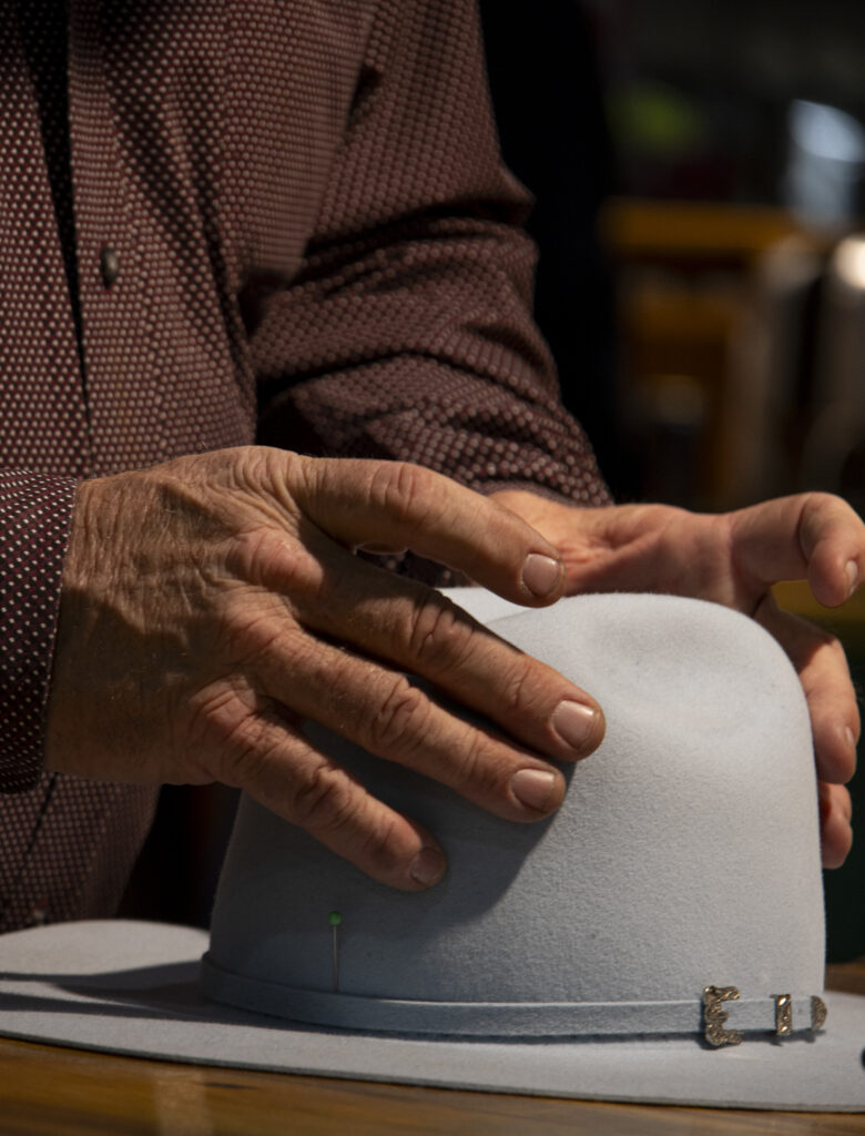 Billy Trbadwell, an employee for the Heads or Tails Hats Boutique, shapes a hat for a customer in the Expo Hall at the San Antonio Stock Show and Rodeo Feb.12. Photo by Itzabel Lara