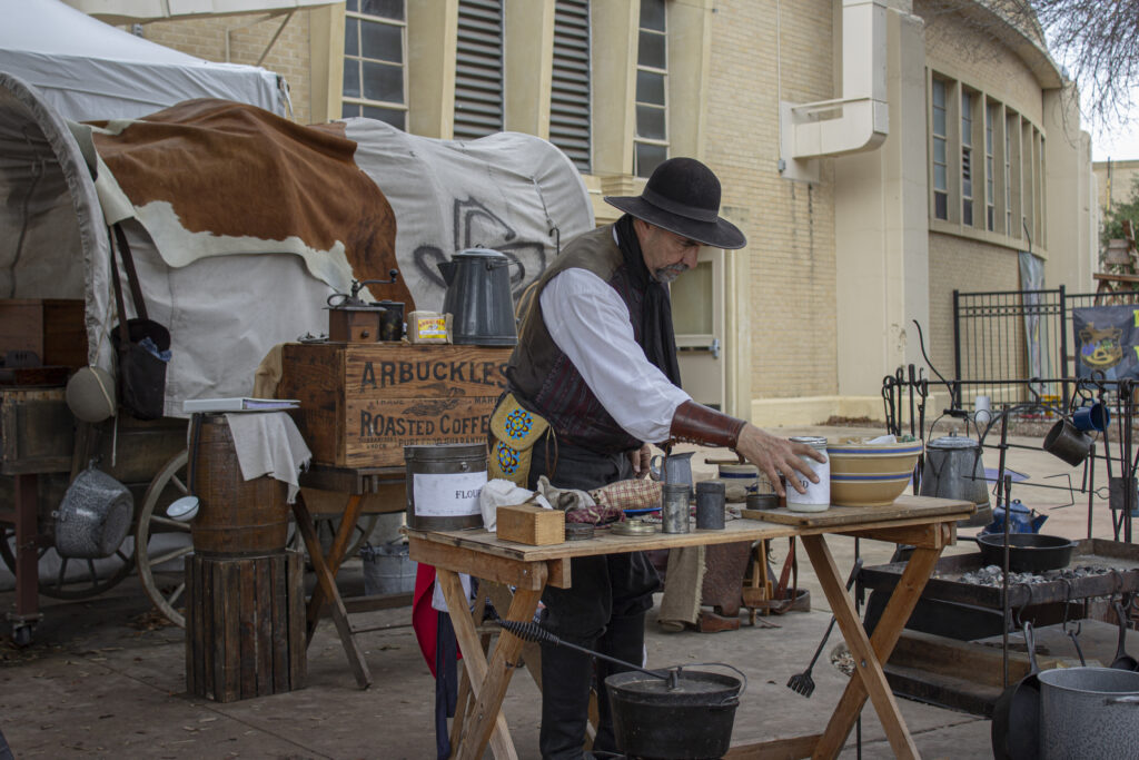 Living Historian Rodney Cromeans preps a table with antique items at the San Antonio Stock Show and Rodeo at The Freeman Coliseum Feb. 12. Photo by Vanessa Wiggins.