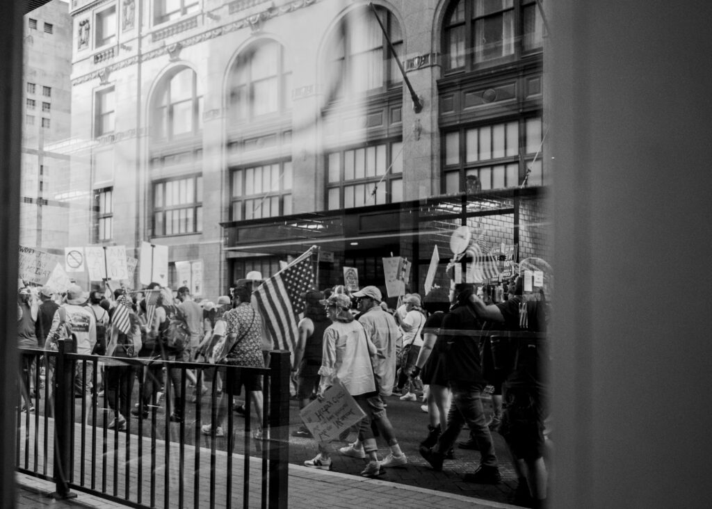 Protesters walk past La Panaderia on Navarro and Houston at the “No Kings” protest Saturday. Photo by Jacob R. Lopez.