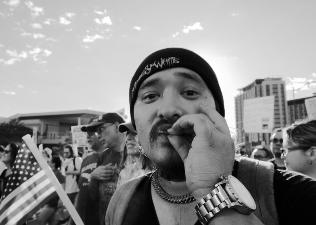 A protester smokes while marching at the “No Kings” protest Saturday. Photo by Jacob R. Lopez.