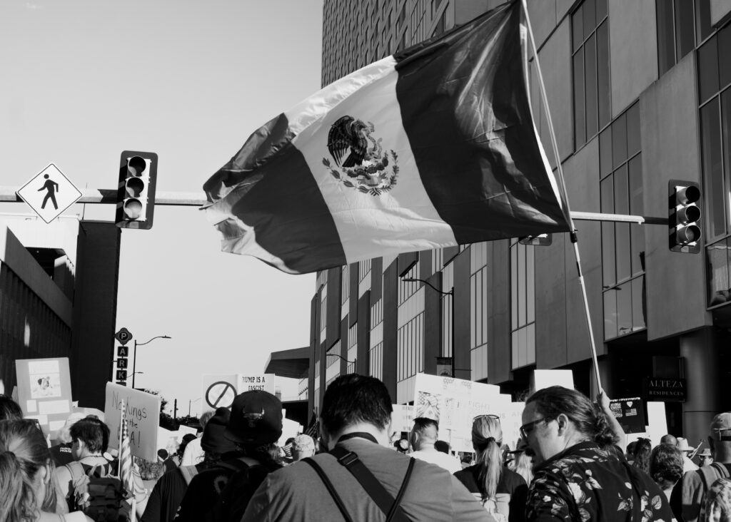 A protester flew a large Mexican Flag at the “No Kings” protest Saturday. Photo by Jacob R. Lopez.