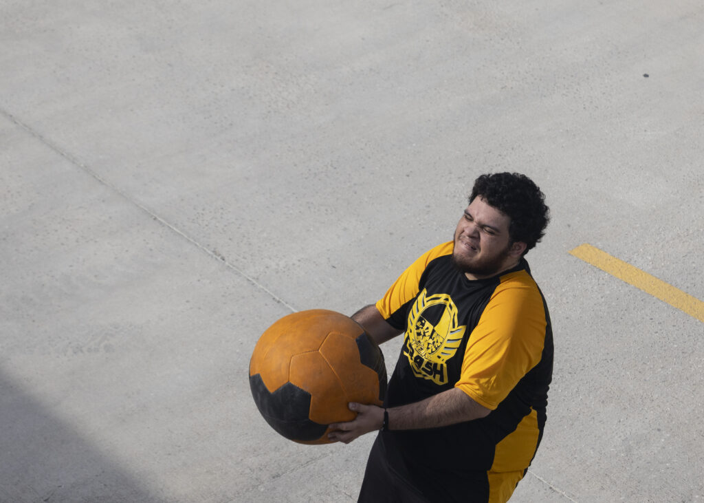 A competitor strains as he throws a medicine ball at Backyard Beast Oct. 24. Photo by Blake White.