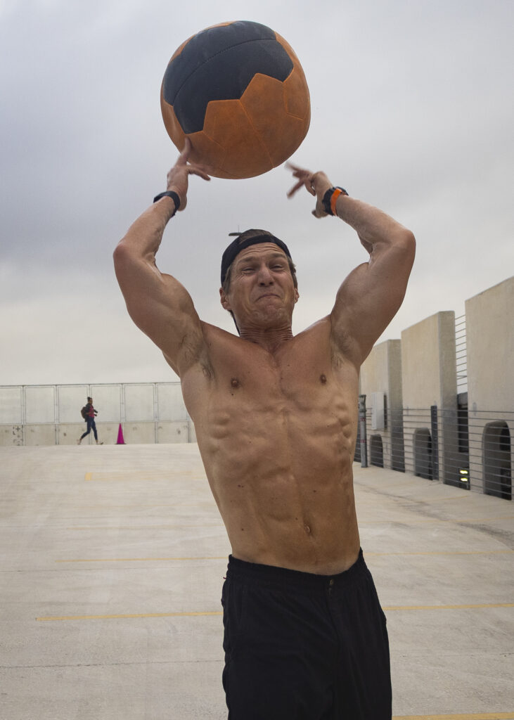A member of Team OTF throws a medicine ball over his head during the Backyard Beast competition Oct. 24. Photo by Chris Hernandez.