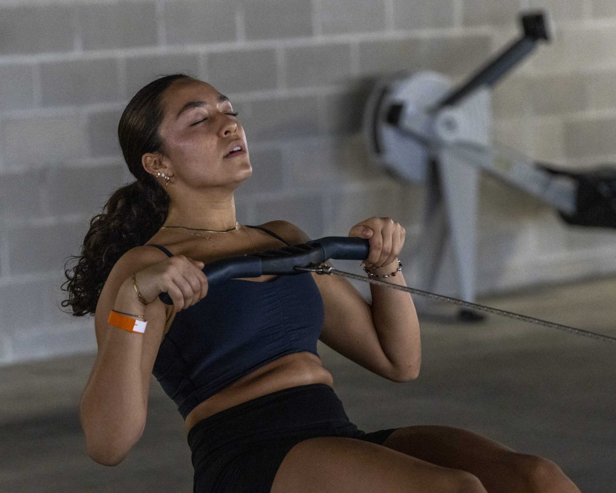 SAC Sophomore Sofia Prieto, a Kinesiology major and member of the “4L Gang” coed team, rows for 500 meters on a rowing machine during the Backyard Beast competition Oct. 24. Photo by Chris Hernandez.