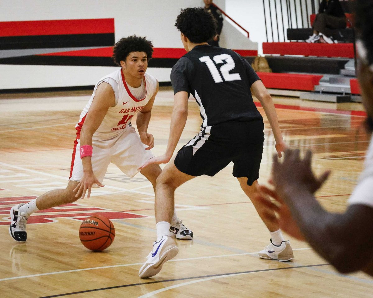 SAC Small Forward Kamirin Williams dribbles against a Tiger defender at SAC’s Chandler Physical Education Center Wednesday. Photo by Thomas Solis.