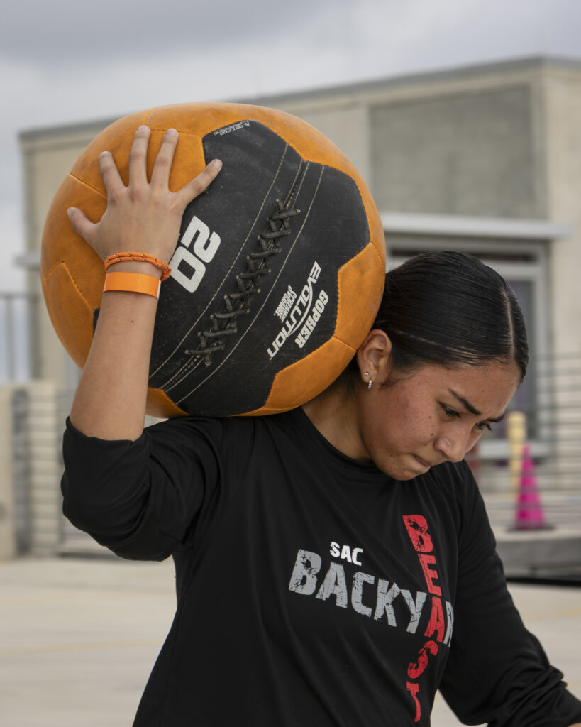 A competitor runs with a medicine ball at Backyard Beast Oct. 24. Photo by Sarah Marguerite.