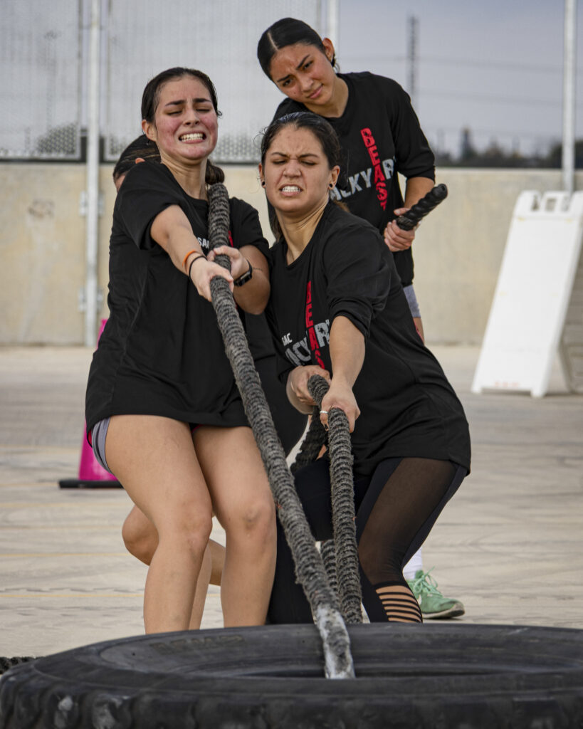 A team of women pull a tire in the final station of the Backyard Beast competition Oct. 24. Photo by Blake White.