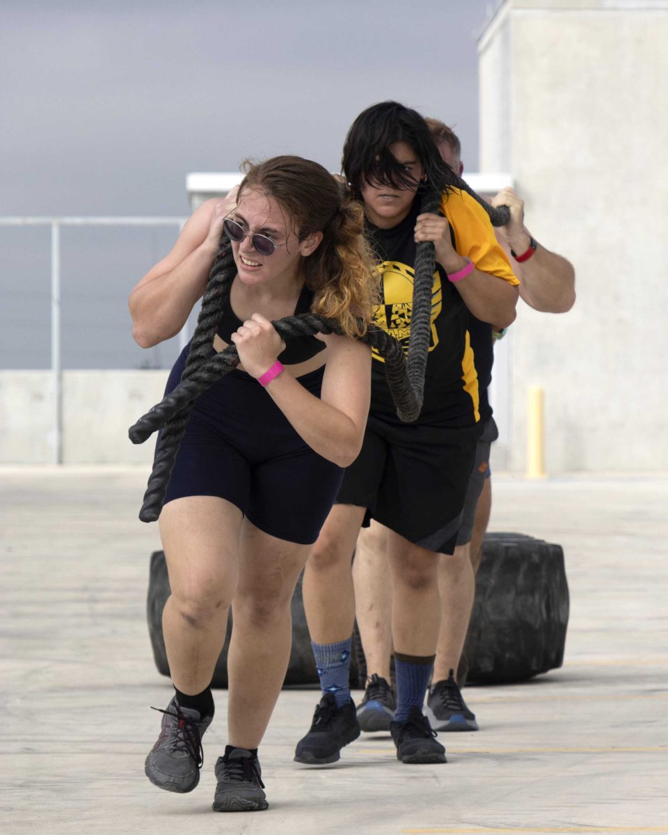 A coed team pulls a tire in the final station of the Backyard Beast competition Oct. 24. Photo by Zoe Jane.