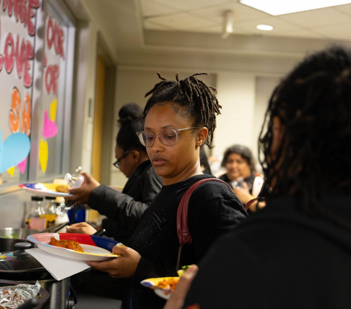 Students help themselves to the food in the "Blue" section at the Hunger Banquet event at San Antonio College, Feb. 17 