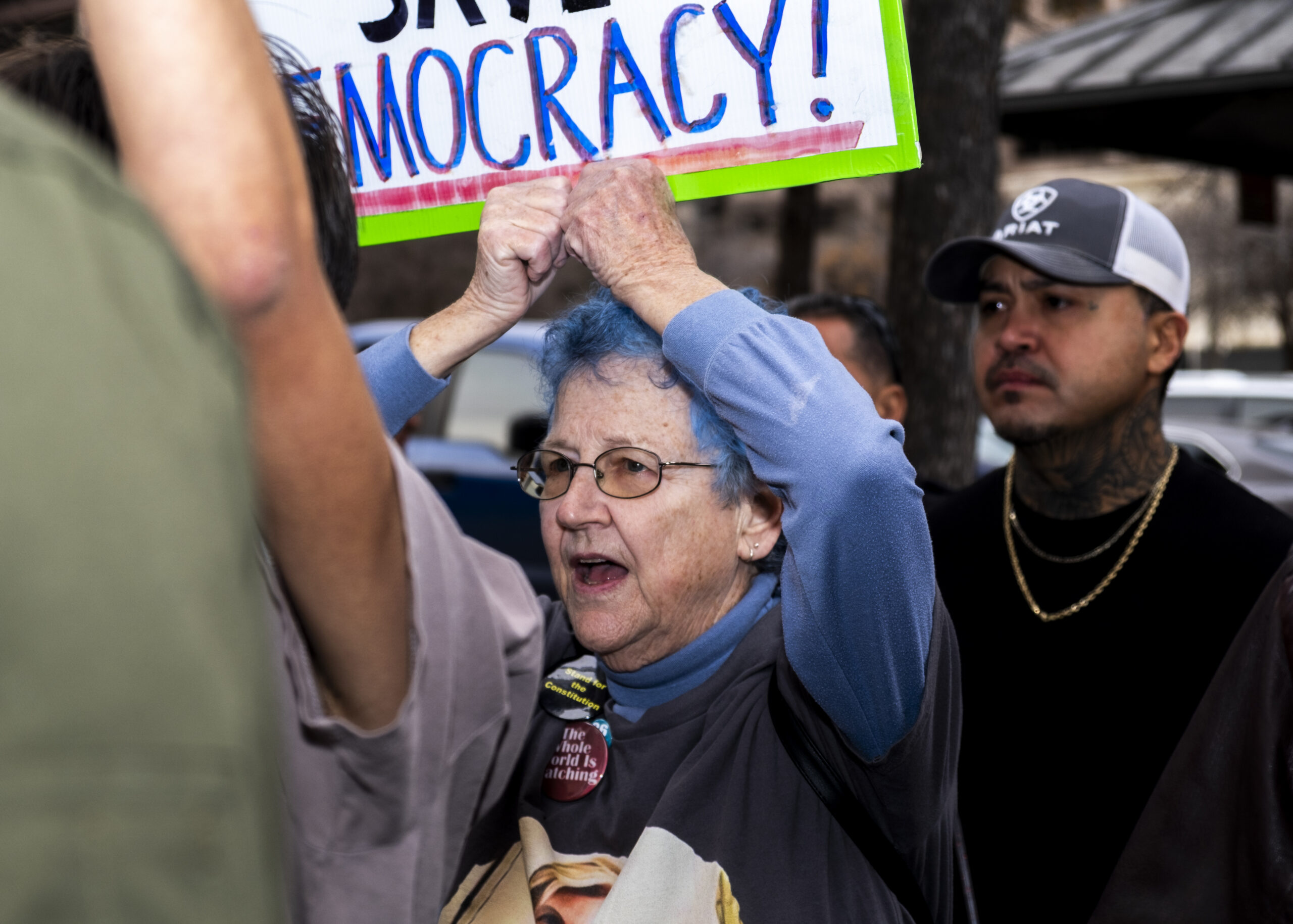 A protester holds up a sign as she marches through N St. Marys Friday. Photo by Jacob R. Lopez.