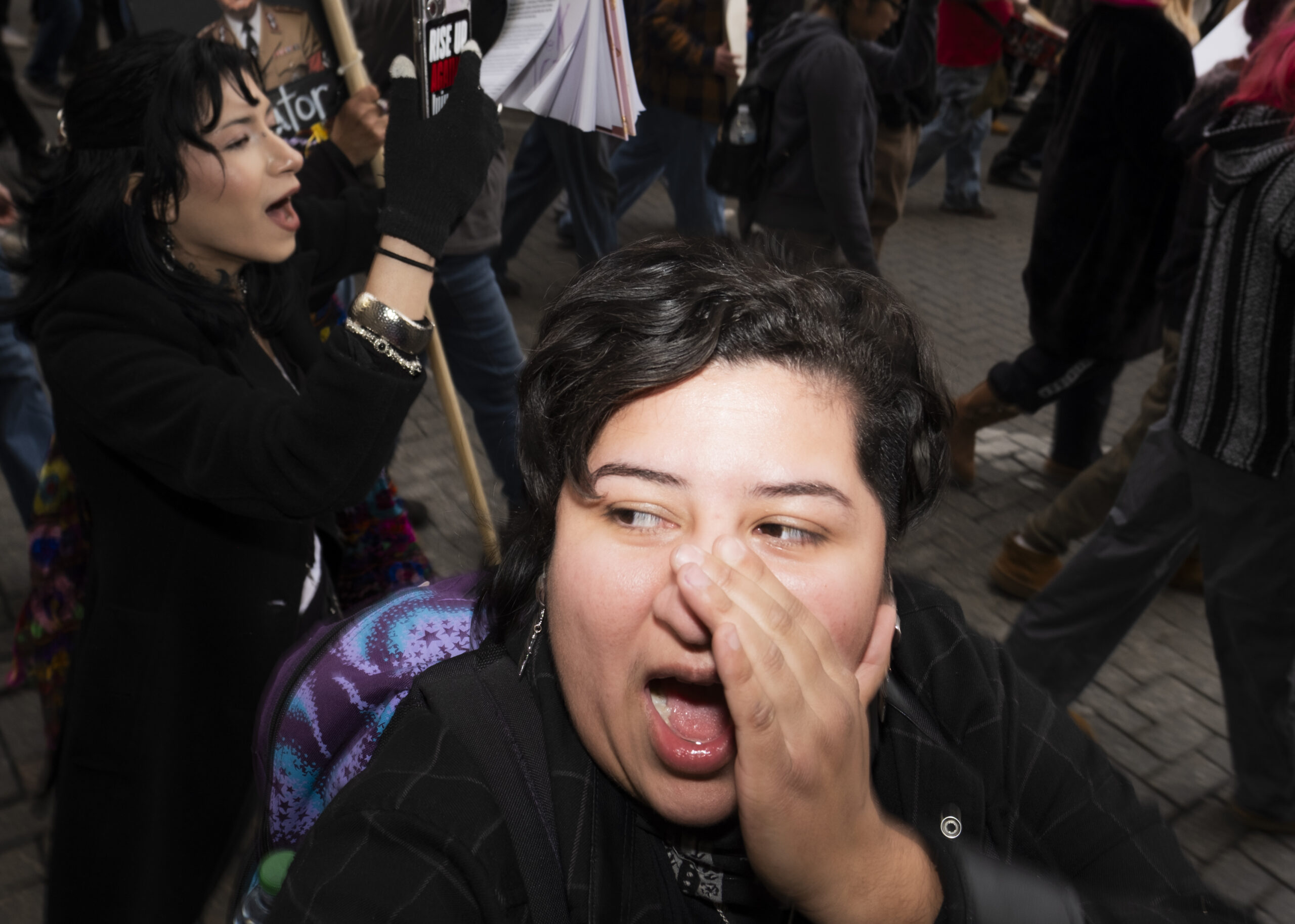 A protester yells “shame” as a counter protester yells at the crowd from a balcony at the Westin Riverwalk Hotel on Friday. Photo by Jacob R. Lopez.