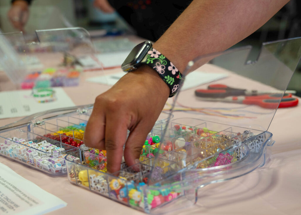 Common Thread volunteer coordinator Ema Avila takes beads to make a bracelet at the Valentine Creation event in the Loftin Student Center Feb 12. Photo by Catie Broadus.