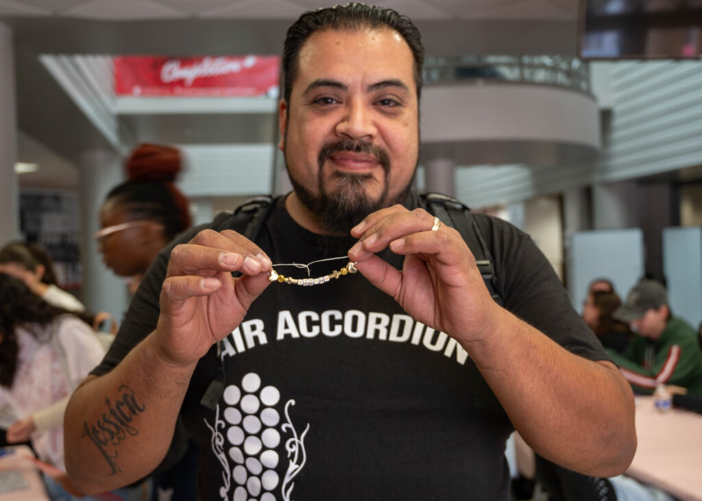 Student David Leon poses with his finished bracelet at the Valentine Creation event in the Loftin Student Center Feb 12. Photo by Catie Broadus.