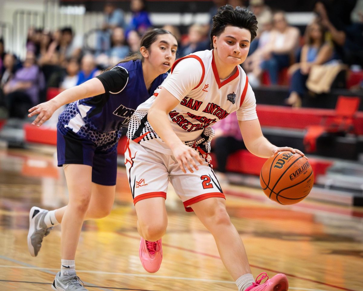 SAC point guard Kayli “Angel” Carrisalez drives past a NVC defender Wednesday at the Candler Physical Education Center. Photo by Janelle Aleman.