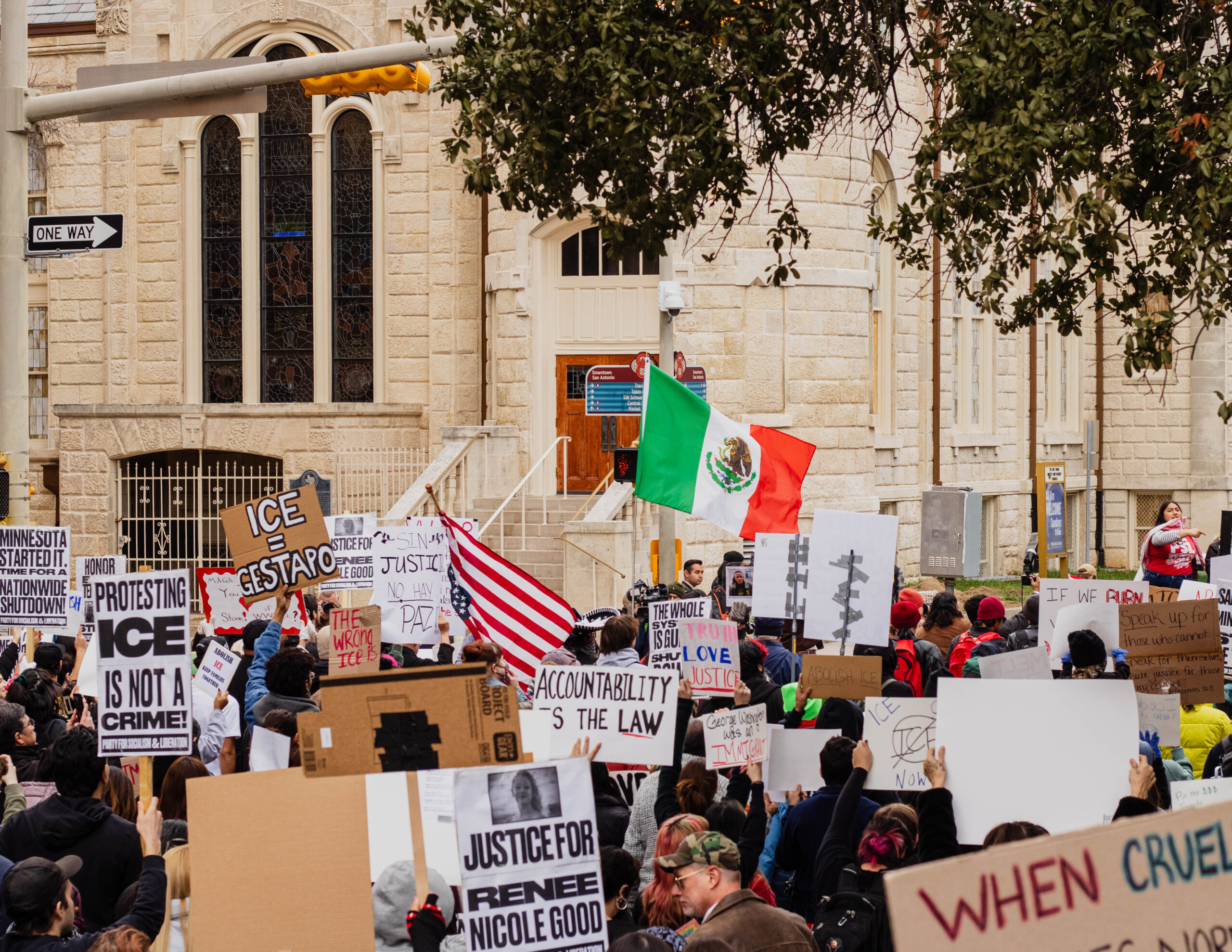 Hundreds of people march along E Travis to protest recent fatal shootings involving federal agents in Minneapolis. Photo by Hailey Vilegas.