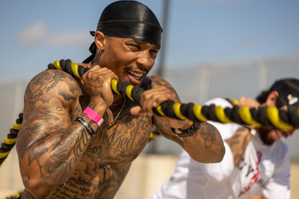 Competitors pull the tire together at the Backyard Beast competition, March 27.