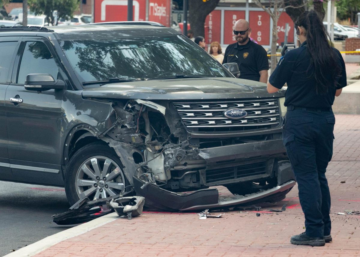 Police investigate a vehicle accident in which a man driving a gray Ford Explorer hit a woman outside of SAC's Fletcher Administration Building Monday afternoon. Photo by Catie Broadus.
