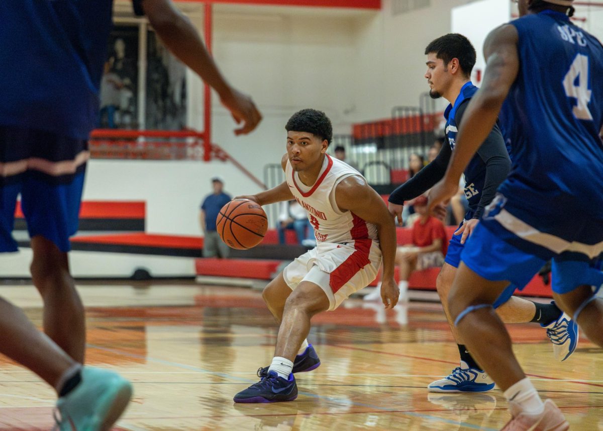 SAC Guard Demetrice Mims looks for a window to drive his way to the basket between three St Philips Defenders.