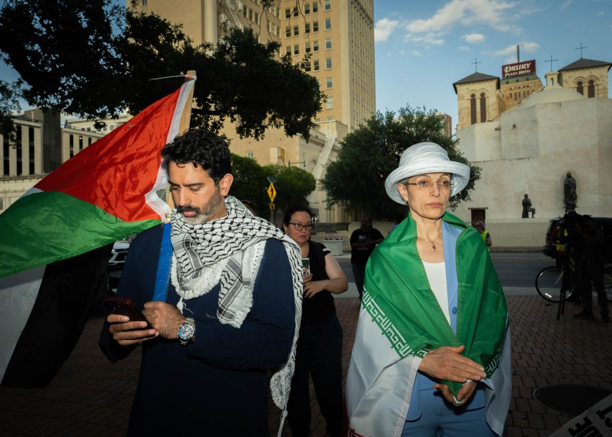 sakib shaik and rashin mazaheri listen to Party for Socialism and Liberation speakers at San Antonio City Hall.