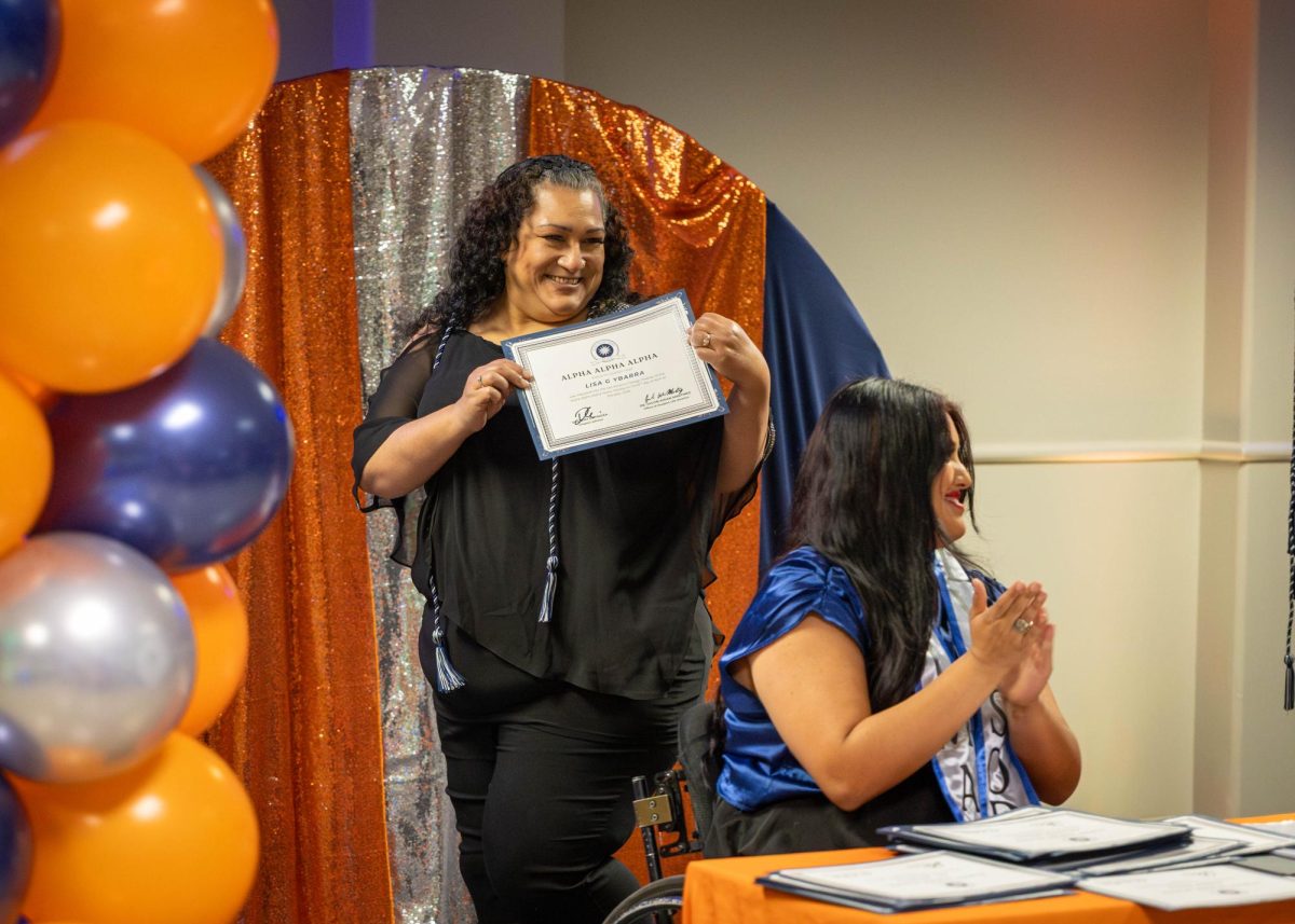 Lisa Ybarra, a deaf support specialist major, receives her certification at the Tri-Alpha Induction Ceremony on Wednesday.