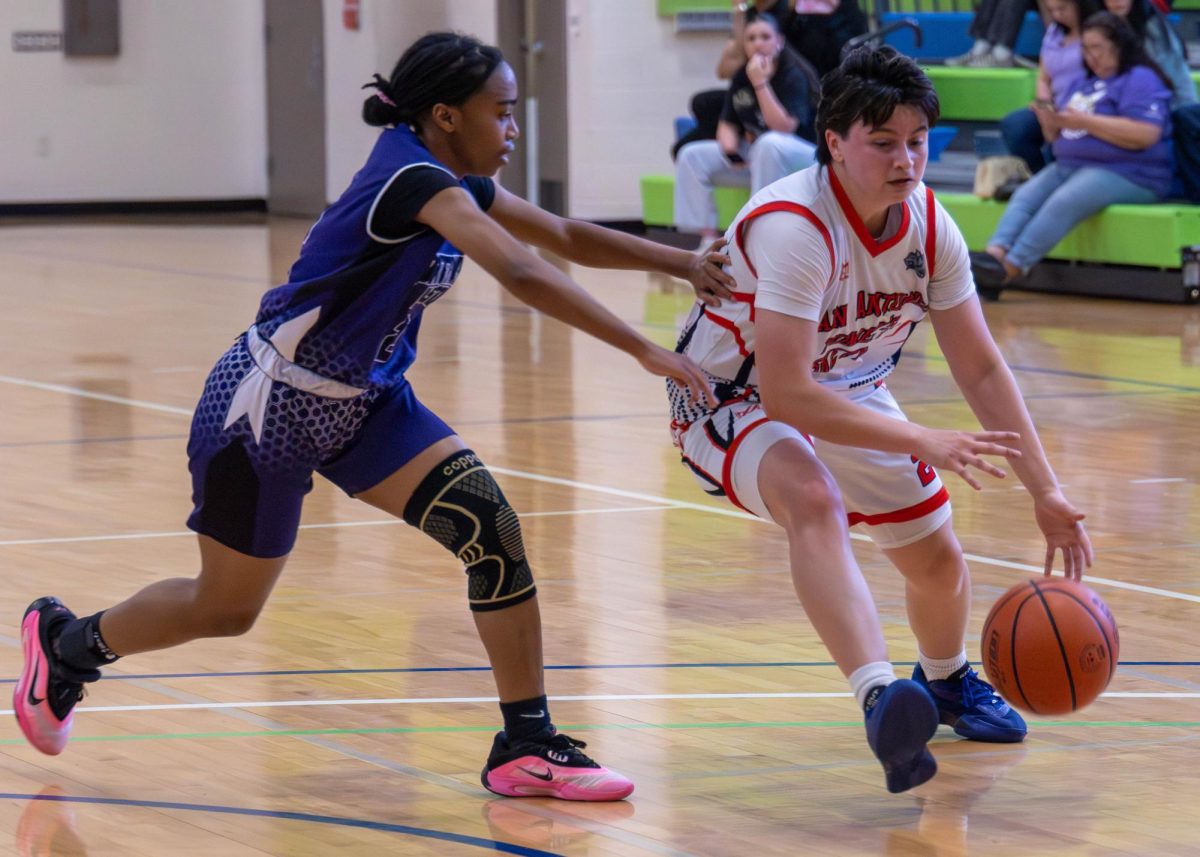 Small forward Kayli "Angel" Carrisalez  drives past an NLC defender at the Llano Wellness Center Saturday.