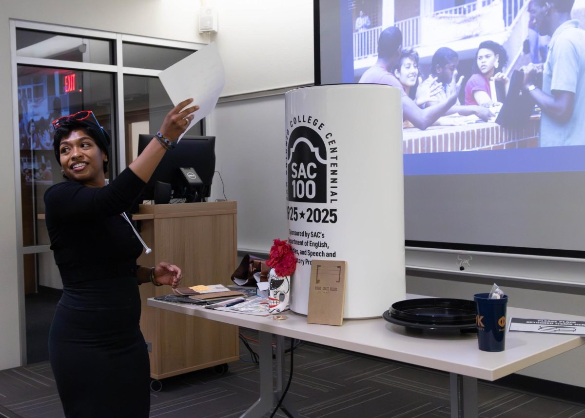 Journalism major Angela Ludlow drops her testimonial into the time capsule, which will be opened in 50 years, during the Time Capsule event on Tuesday, April 28.
