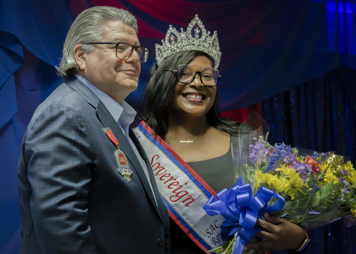 Rayshunda Dawson, SAC business major and PTK president, stands next to SAC President Dr. Francisco Solis after being crowned Sovereign at the Fiesta Coronation in the fiesta room  at the Loftin student center, Thursday April 2.