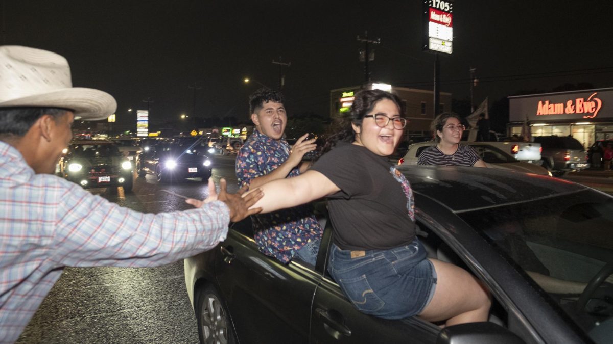 San Antonio Spurs fans gather on Southwest Military Drive, honking up and down the street after a historic Game 1 win in the Western Conference Finals Monday. 