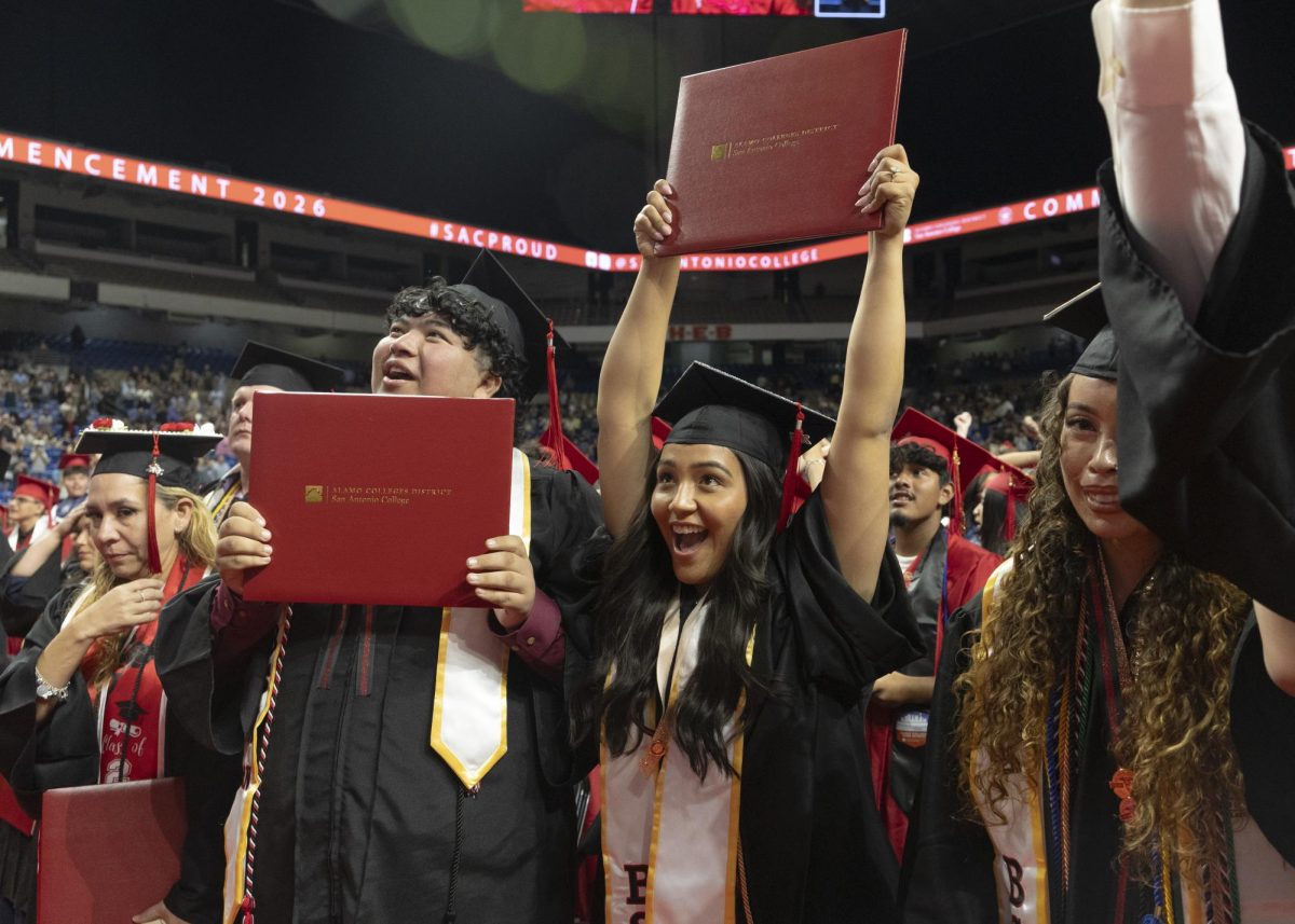 SAC Graduates hold up their diplomas at the Alamodome May 20.