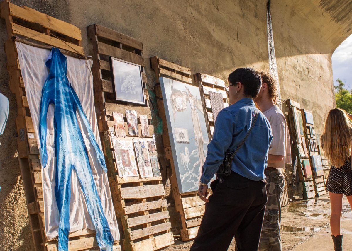 Guests looking at an art piece during the art exhibit on Saturday.