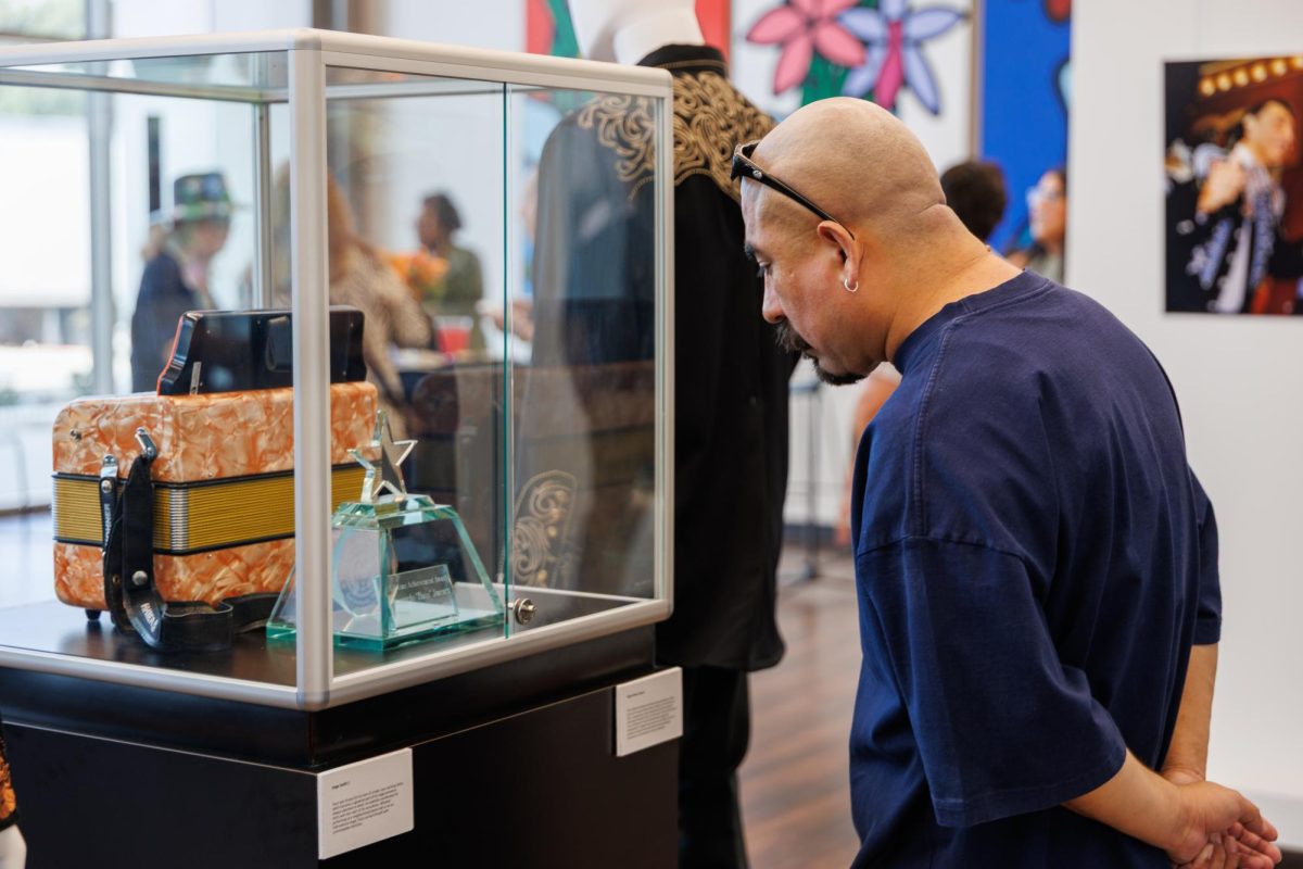 Exhibit guest looks at memorabilia at the opening of "From the Westside to the World: Un Homenaje a Flaco Jimenez.
